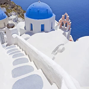 Staircase leading to blue domed church overlooking ocean, Oia, Santorini, Cyclades