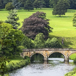 View towards Three Arch bridge over River Derwent, Chatsworth House, Derbyshire, England