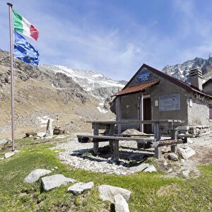 View of Rifugio Tonolini framed by the high peaks Val Malga Adamello Regional Park