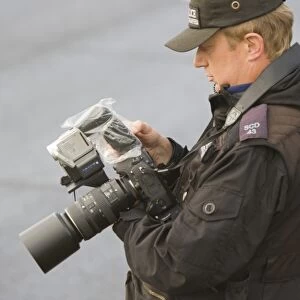 A police photographer photographing protestors at the Climate camp protest against airport development at Heathrow and the village of Sipson that would be demolished to make place for a third