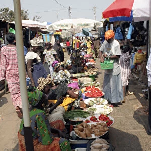 Bakau Market Atlantic Road. Busy market scene with women selling fruit and vegetables