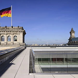 Germany, Berlin, German flag fluttering on a corner tower of the Reichstag building as