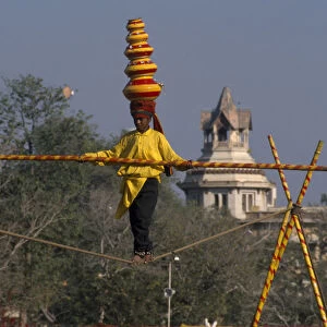 INDIA, Rajasthan, Jaipur Young boy balancing on the high wire at the Jaipur Heritage