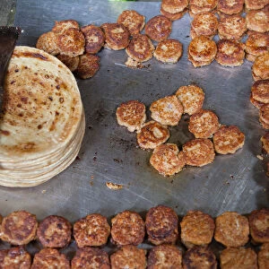 India, Uttar Pradesh, Faizabad, Display of cooked parathas and mutton patties in a food hotel