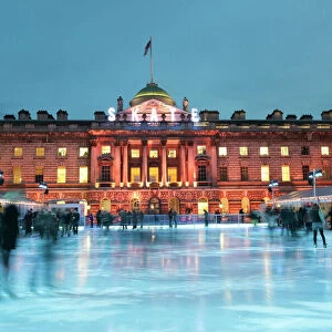 Skaters, early evening on the seasonally assembled ice rink at Somerset House, London