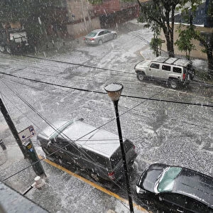 Hail falls on a street during rain in Mexico City