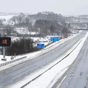 The M80 motorway is completely empty after being closed to clear vehicles stranded by bad
