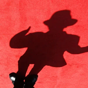A shadow of a dancer impersonating Michael Jackson is cast on the red carpet during