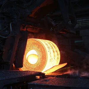 A steel coil is unrolled on the line at the Novolipetsk Steel PAO steel mill in Farrell