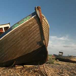 Abandoned fishing boats on shingle beach, Dungeness, Kent, England, June