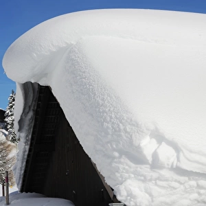 Deep snow on chalet roof, Davos, Graubunden, Swiss Alps, Switzerland, january