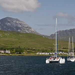 View of yachts moored in bay, with Beinn Shiantaidh and Corra Bheinn, Paps of Jura in background, Craighouse Bay