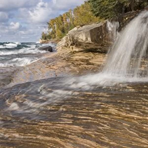 Waterfall flowing into freshwater lake, Lake Superior, Picture Rocks N. P. Upper Peninsula, Michigan, U. S. A. october