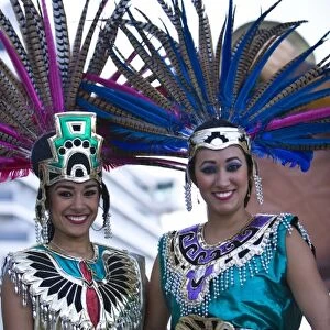 22 year old Hispanic sisters, Aztec outfits, feather head dress with Pheasant feathers