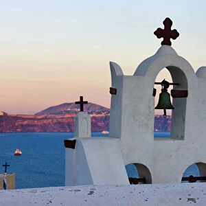 Church bell tower on the coast of Aegean Sea. Oia, Santorini Island, Greece