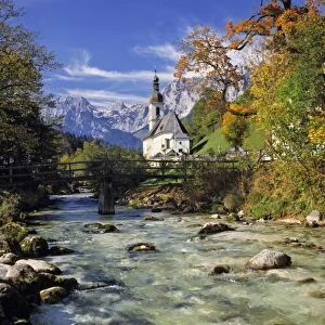 Germany, Bavaria, Ramsau. The fall foliage adds to the beauty of this small church