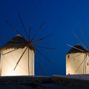Greece, Mykonos, Hora. Three windmills lit at sunset