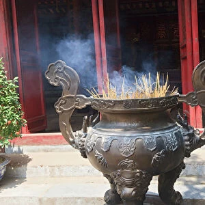 Hanoi, Vietnam. Incense offering at Ngoc Son Pagoda (Temple of the Jade Mound), a