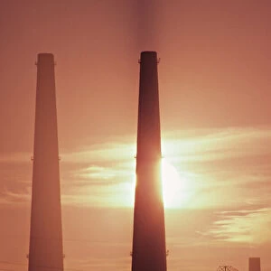 Industrial stacks at sunset