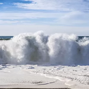Massive breaking wave on a beach in northern California
