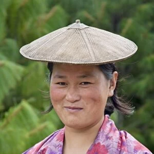 Portrait of a farmer wearing bamboo hat, Bumthang, Bhutan. (MR)