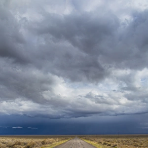 USA, Nevada. Road into approaching storm. Credit as: Don Paulson / Jaynes Gallery / DanitaDelimont