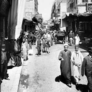 EGYPT: CAIRO. A view of Muski Street with traffic, including people walking, riding donkeys