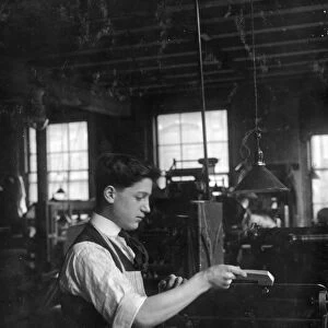 HINE: CHILD LABOR, 1917. A boy operating an automatic press at the Boston Index Card Company