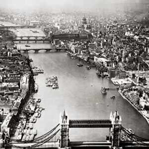 LONDON: AERIAL VIEW, 1946. Aerial view of London, England, looking west along the Thames River from the Tower Bridge (foreground). Photographed in 1946
