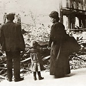 WWI: REFUGEES, 1918. A French family viewing the rubble of their home, destroyed