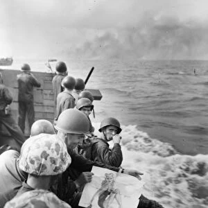 WWII: MARINES, 1943. American marines at leisure on a landing barge as it approaches