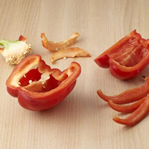 Red bell pepper cored and cut into strips with kitchen knife