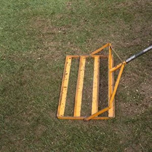 Using a lute to work in top dressing on a lawn