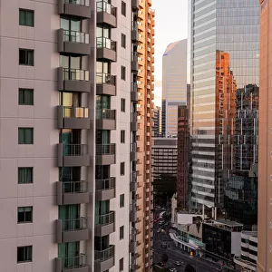 looking through tall buildings at sunset in Brisbane down onto the road
