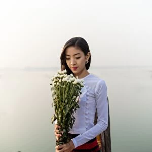 Burmese girl with flowers In the morning