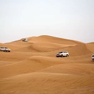 Off-road Vehicles Navigating Down a Sand Dune. Hatta, United Arab Emirates