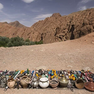 Vendor displays souvenirs and trinkets on blanket alongside road, Dades Gorge, Morocco