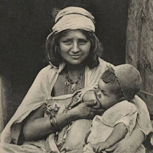 Arab woman feeding her baby (b / w photo)