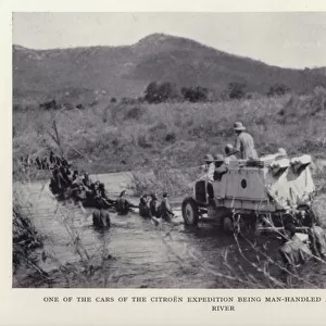 One of the cars of the Citroen expedition being man-handled across the Ruaha river (b / w photo)