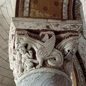 A dragon eating a man, carved capital of the chancel