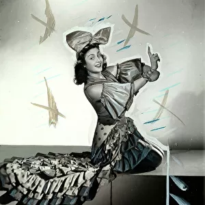 Portrait of the ballerina Nina Kara, in costume performing a dance step