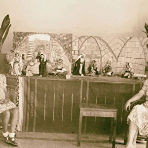Woman girl seated front dolls wearing traditional
