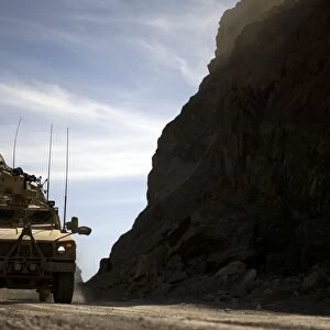 A MRAP vehicle drives through the mountains of Afghanistan