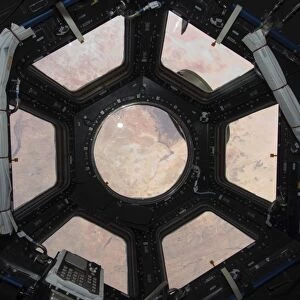 The Sahara Desert visible through the windows of the cupola on the Tranquility module