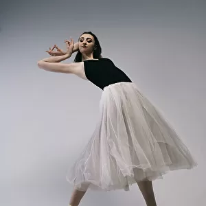 The courage. a young ballerina in a black skirt and Chopin is standing on pointe shoes