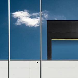 Two flagpoles, a cloud and a window