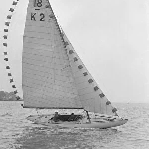 The 18-foot keelboat Prudence (K2) with prize flags, 1922. Creator: Kirk & Sons of Cowes