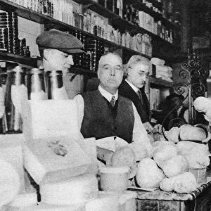 A customer inspects a haggis, London, 1926-1927