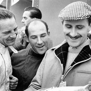 Brussels, Belgium. 8 April 1960: Left-to-right: Innes Ireland, Stirling Moss and Graham Hill. Portrait
