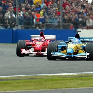 Formula One World Championship: Jenson Button Renault R202 is chased by a fast recovering Rubens Barrichello Ferrari F2002 who finished second